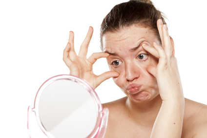 young woman making faces on the mirror